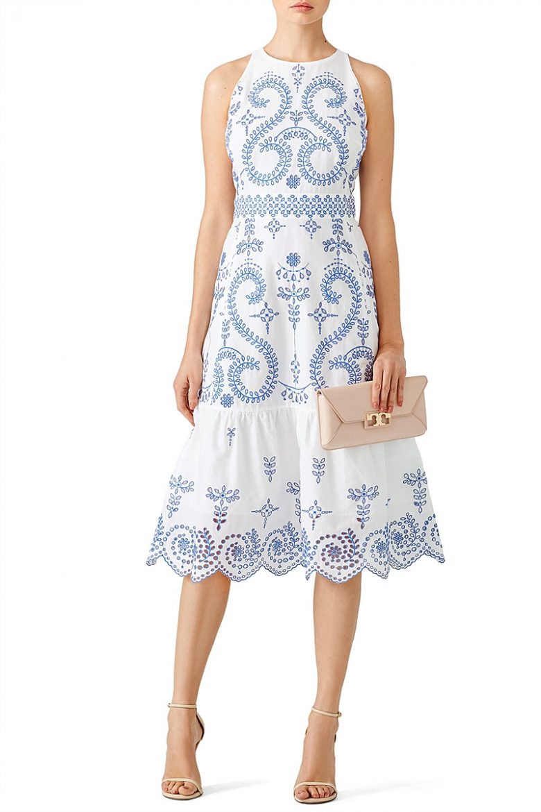 sleeveless fitted white dress with blue embroidery and ruffle bottom