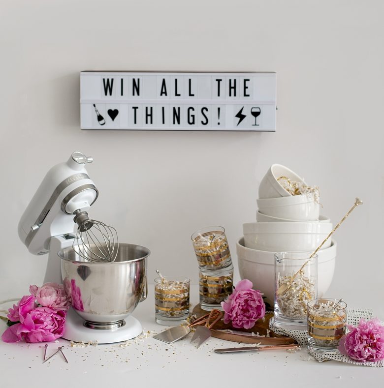 win all the things, full crate and barrel giveaway set, mini kitchenaid mixer, white prep and mixing bowls, cocktail pitcher and spoon, four gold striped old fashioned glasses, wooden cheese board, cheese knife set, napkins