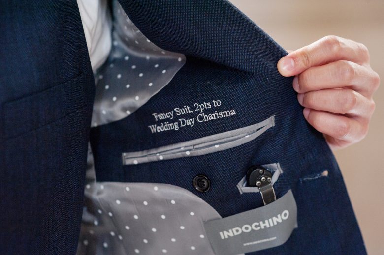 Embroidery inside jacket, which reads: Fancy Suit, 2pts to Wedding Day Charisma