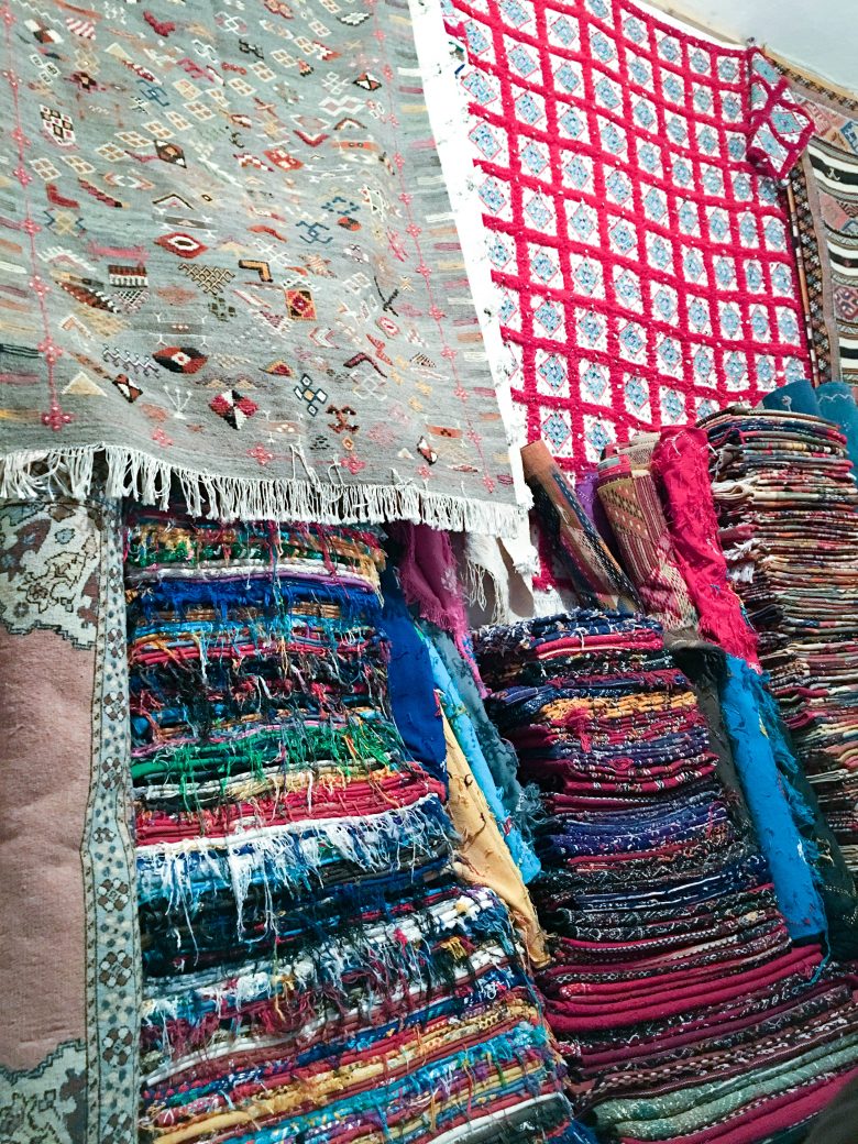 Piles of colorful moroccan carpets 