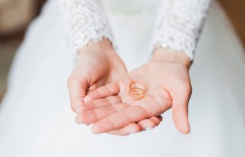 woman holding wedding rings