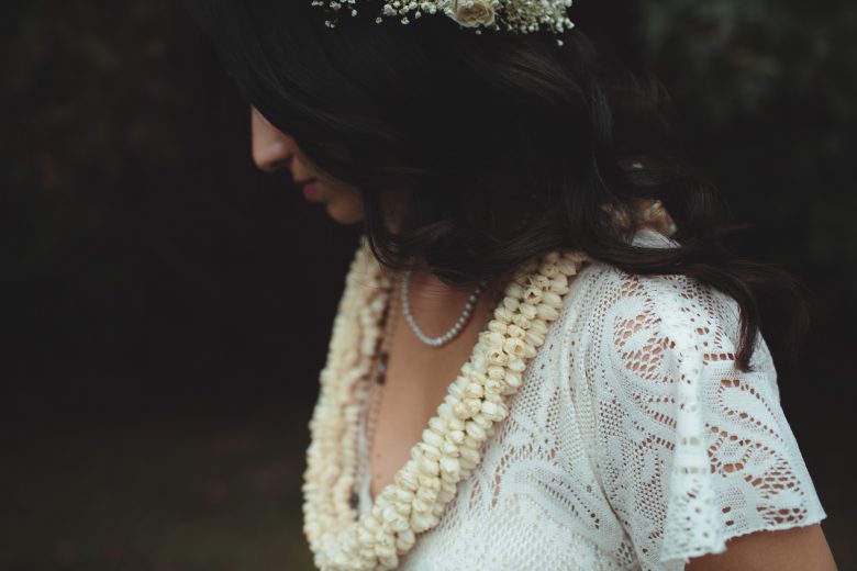Bride with lei and flower crown, from side