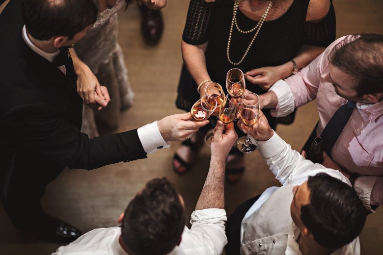 overhead of people toasting with champagne glasses