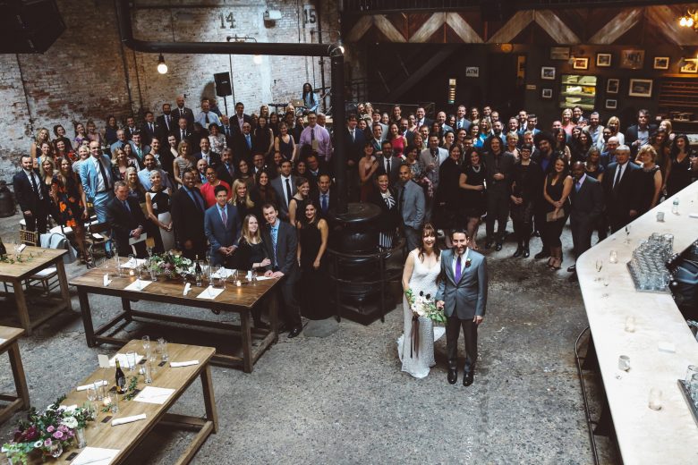 Entire wedding (party and guests) at reception in industrial space
