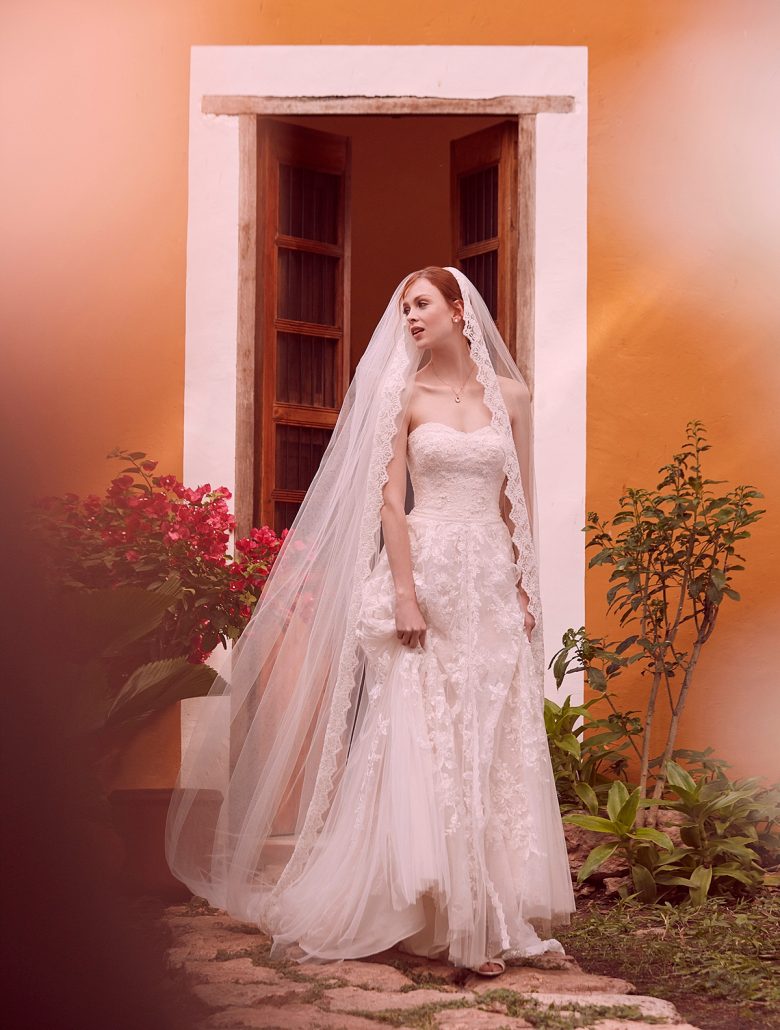 Woman wearing A-Line Wedding Dress and lace-trimmed veil