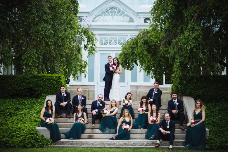 Wedding party on steps of garden