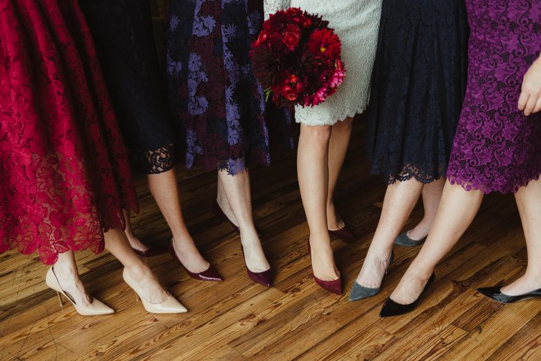 Party shoes of five women in dresses