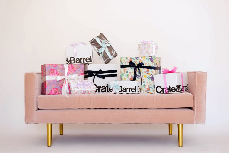 crate and barrel gift boxes and other wrapped gifts on pink velvet love seat