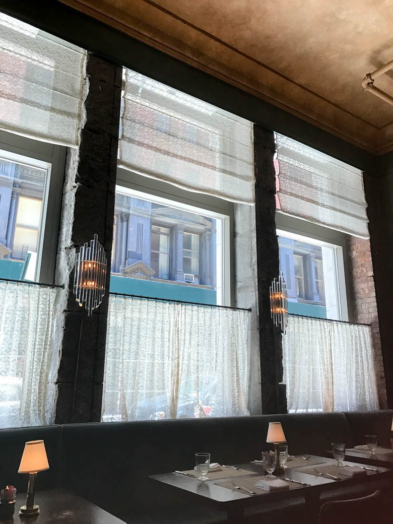 restaurant interior of windows with deco glass sconces 