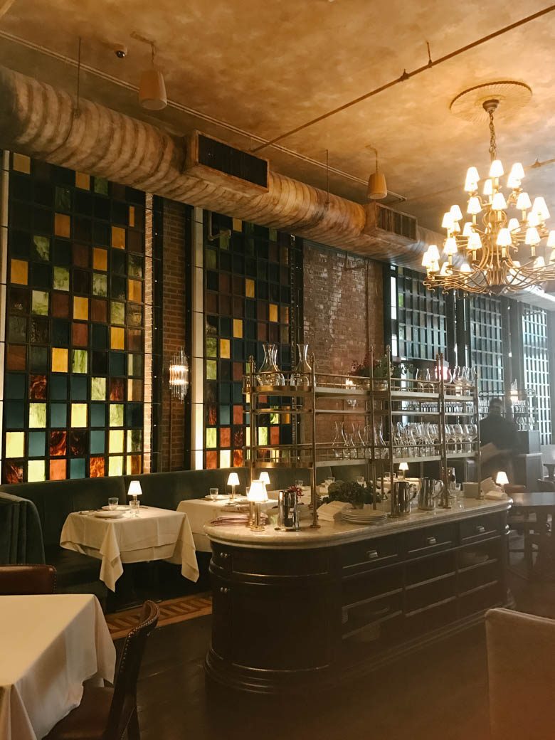 restaurant interior with chandelier and colorful windows
