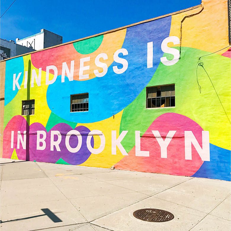 Kindness is in Brooklyn colorful graffiti wall