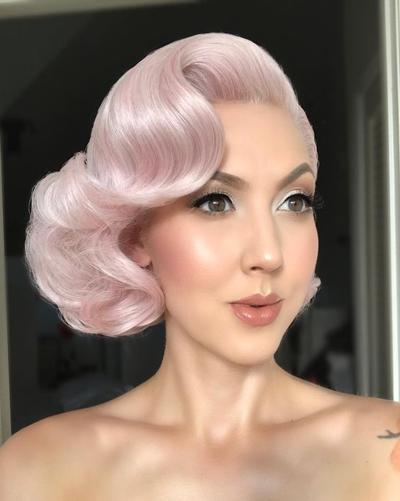 cotton candy pink hair, coifed to chin length, with a vintage ’50s vibe