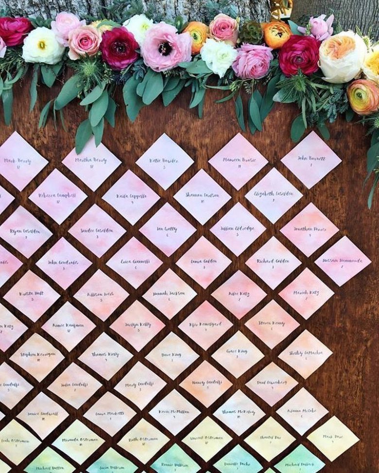 rainbow watercolor diamond shaped escort cards with flowers