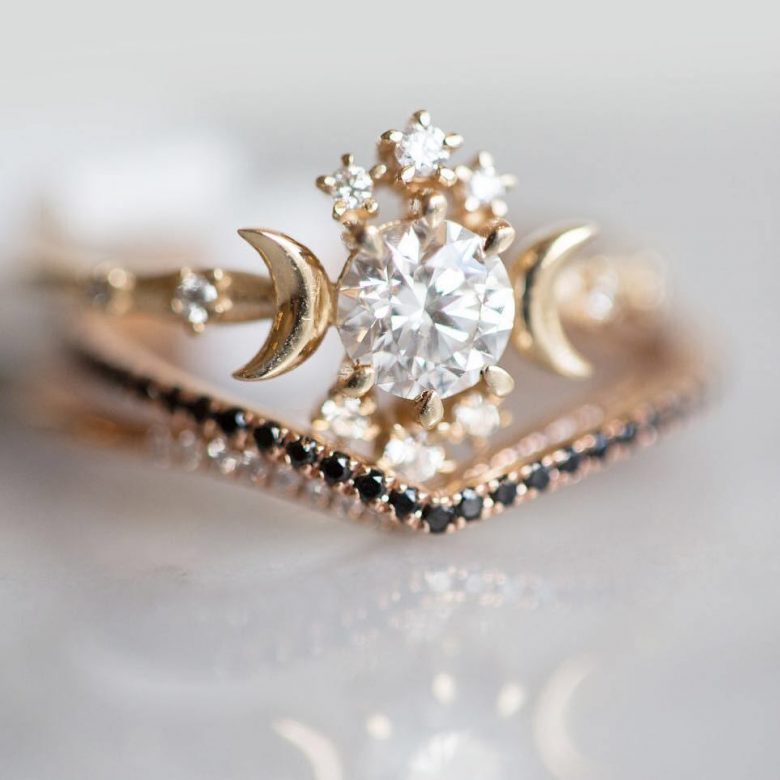 stacked rings: celestial themed ring with thin black jeweled band beneath