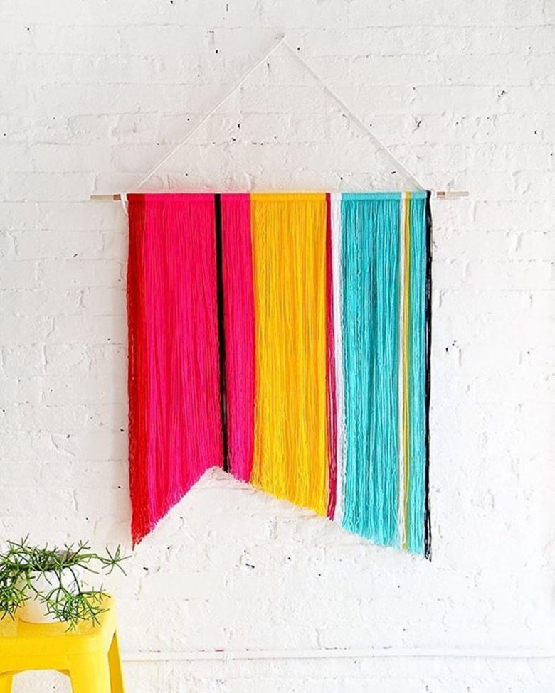 multicolored wall hanging made of brightly colored string