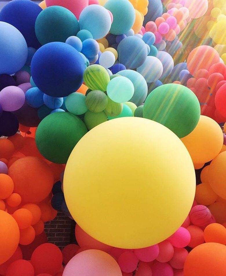 Rainbow colored balloons in many different sizes