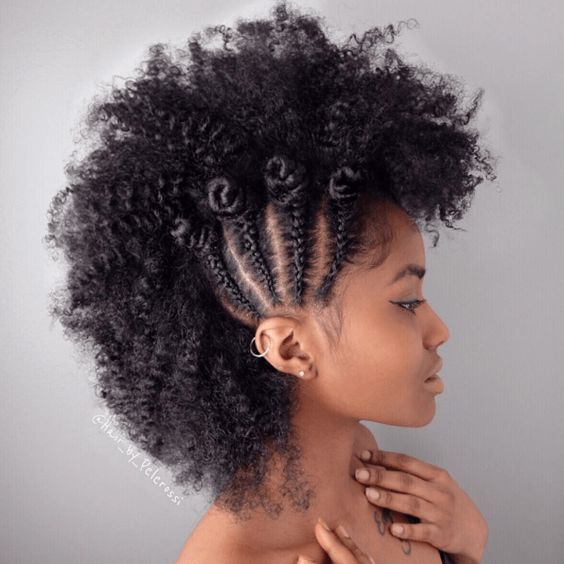 woman with sides braided vertically to create textured curled mohawk