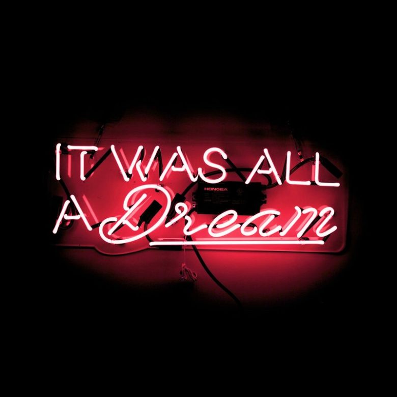 neon sign with words "it was all a dream" in millennial pink neon