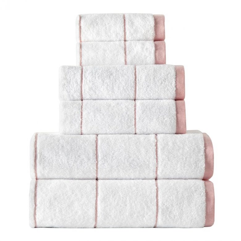 stack of white bathroom towels with millennial pink thin grid line pattern