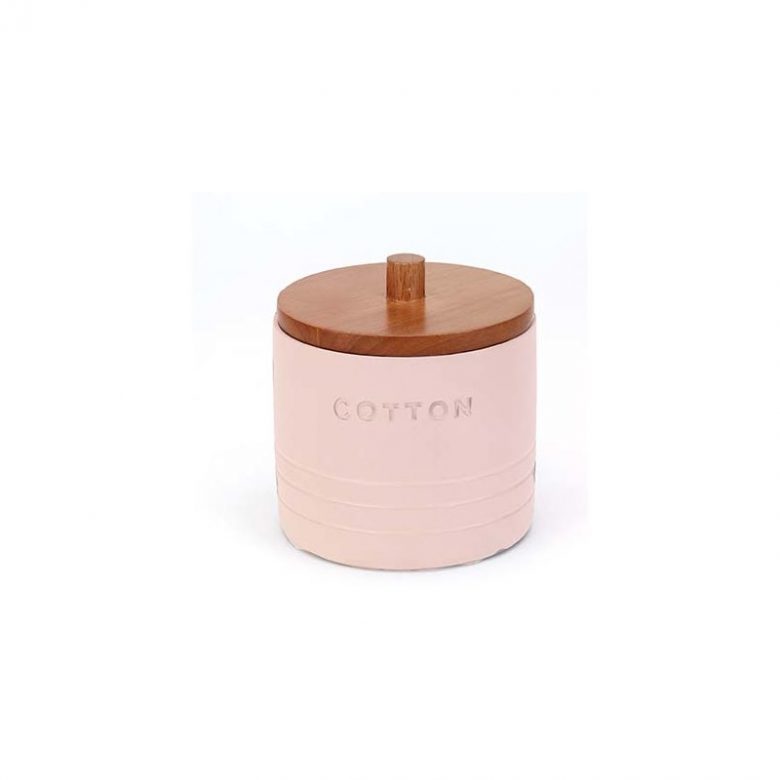 millennial pink ceramic jar with wood lid and word "cotton" stamped on the front