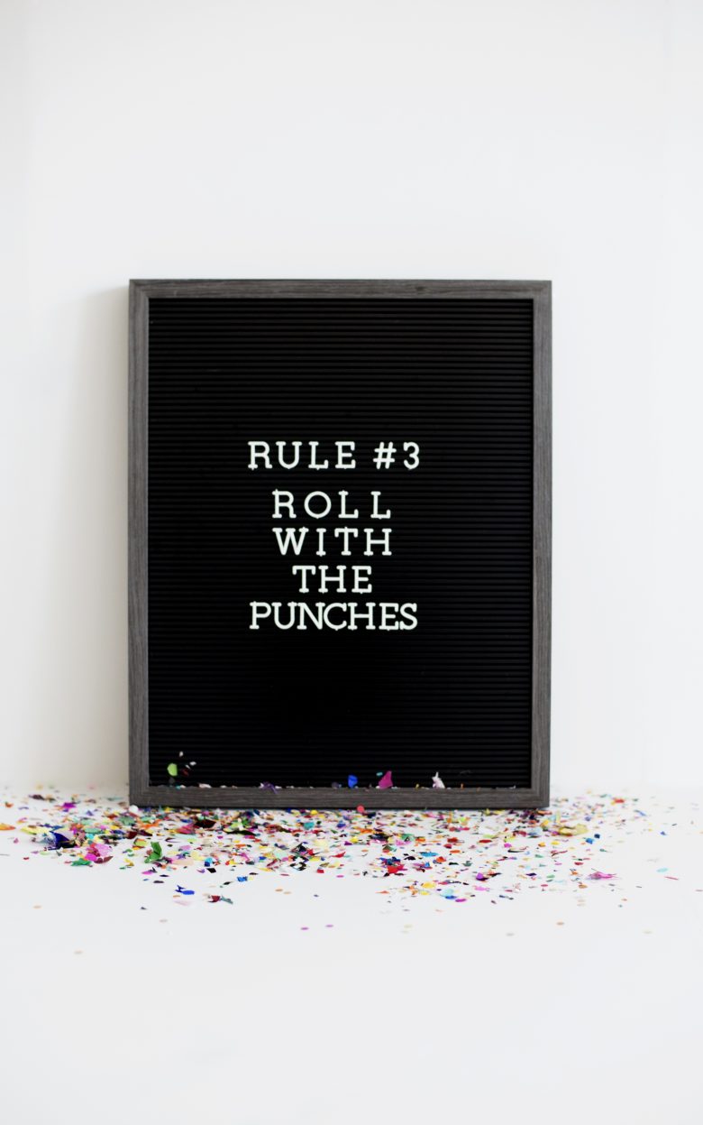 Message board that says Rule Number Three. Roll with the punches.