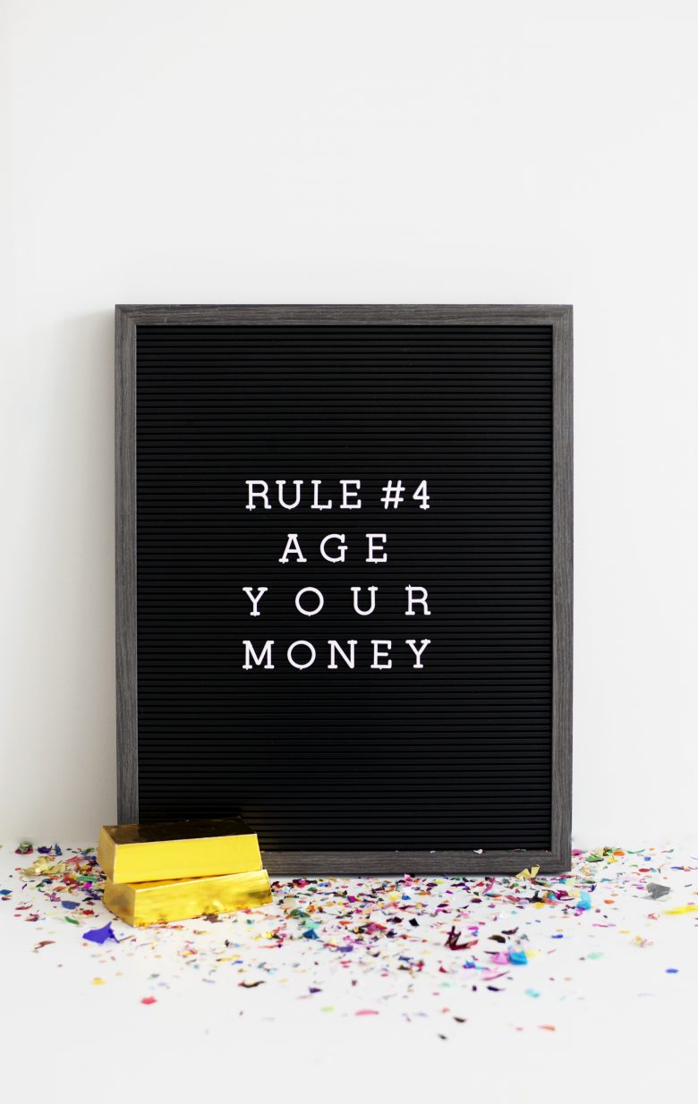 Message board that says Rule Number Four. Age your money.