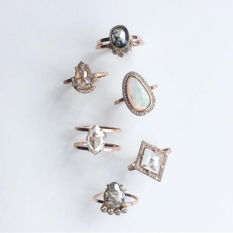 An overhead view of five different engagement rings