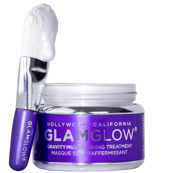 Purple jar of Glamglow skincare firming mask with applicator brush propped to the side