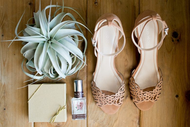 overhead view of wedding shoes and parfume