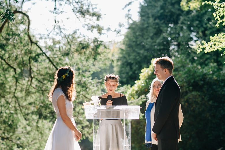 A couple standing at the altar during their ceremony outdoors