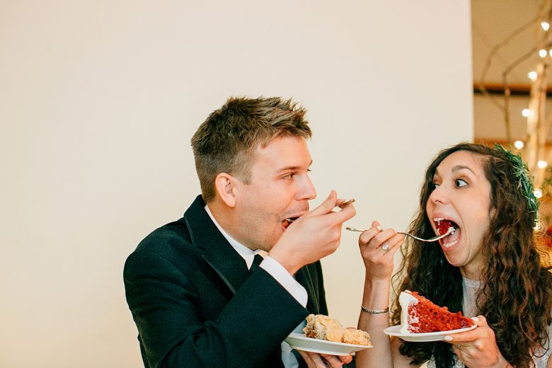 A couple eating their wedding cake