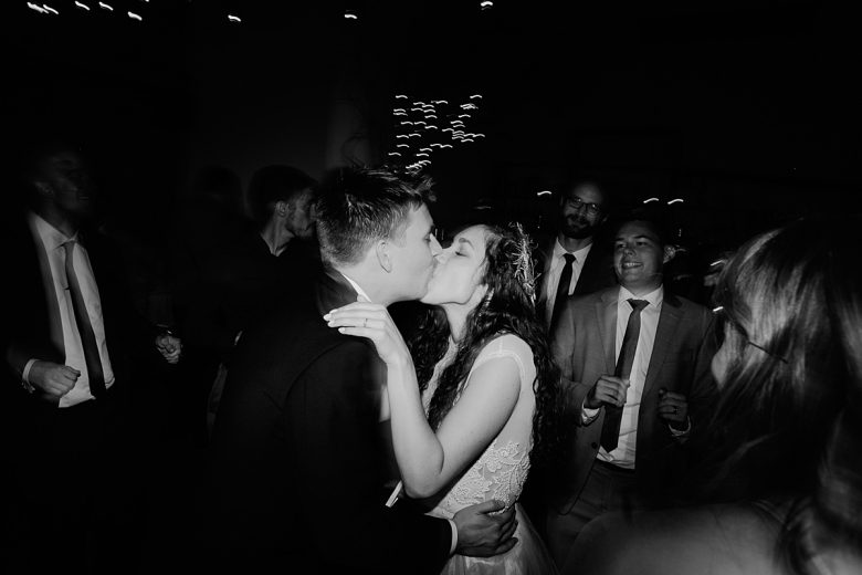 man and woman kissing on the dance floor