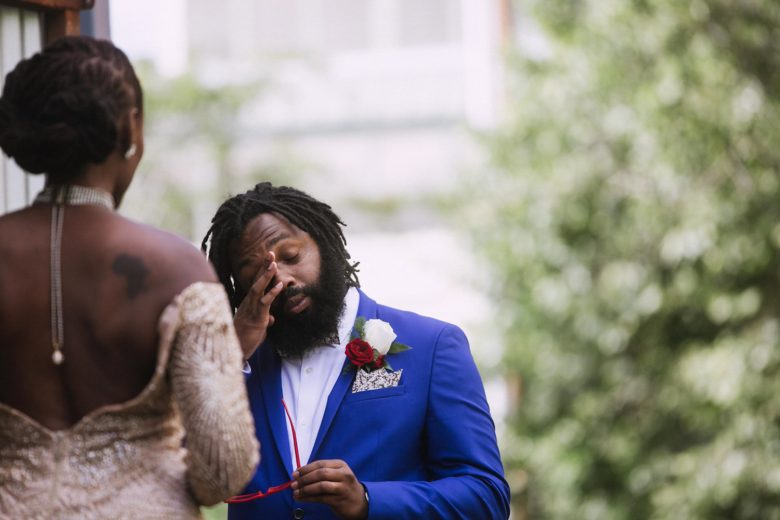 A man wipes away a tear during his wedding ceremony