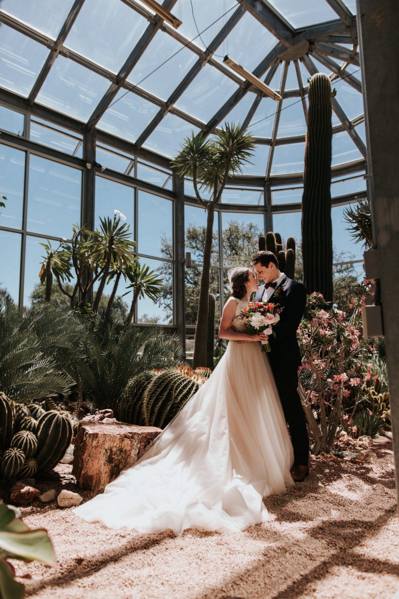 bride and groom inside a desert greenhouse