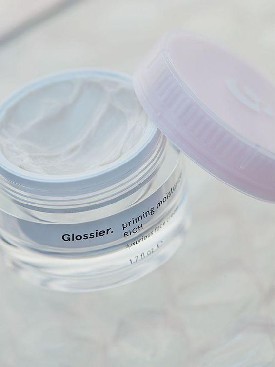 Jar with pink lid with Glossier skincare priming moisturizer rich cream