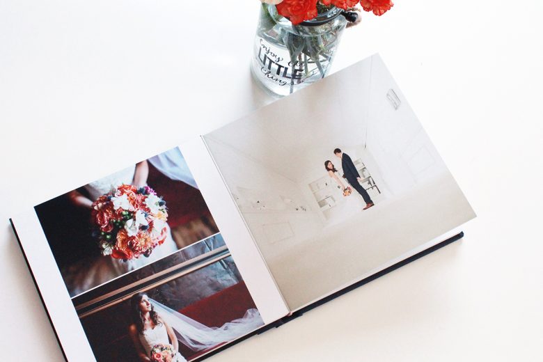 Interior 3-image spread of wedding album next to vase of flowers