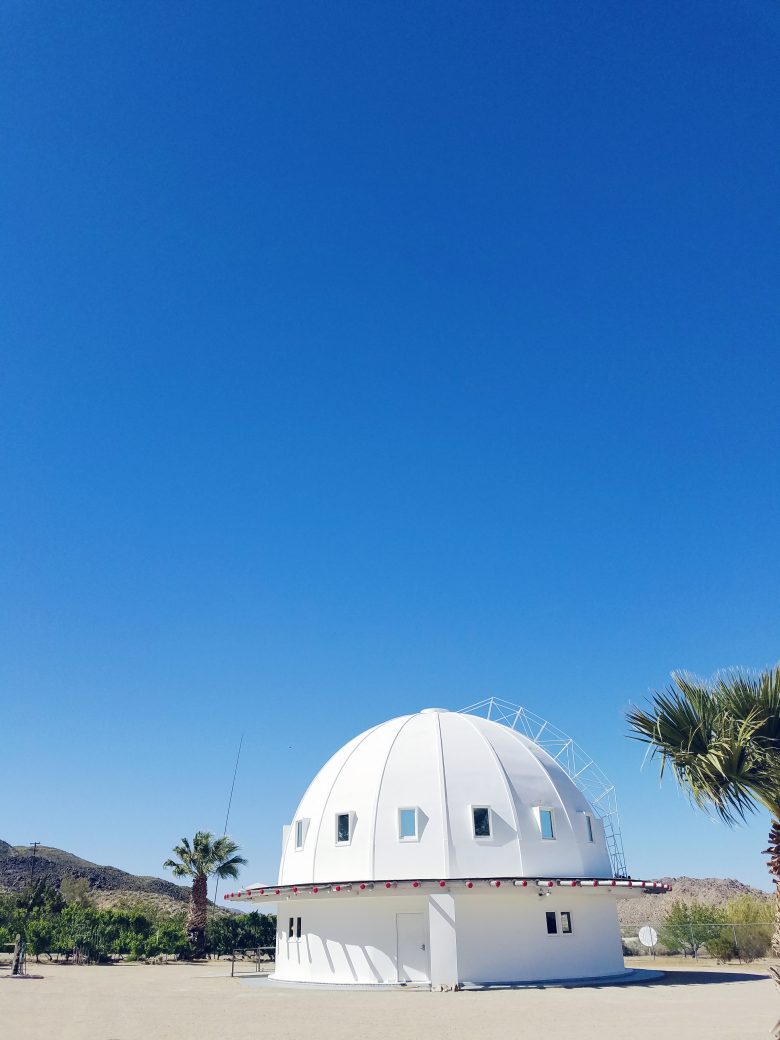 White geodesic dome against blue sky in desert
