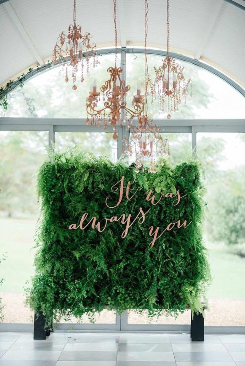 living wall backdrop with words "it was always you" in front of large windows
