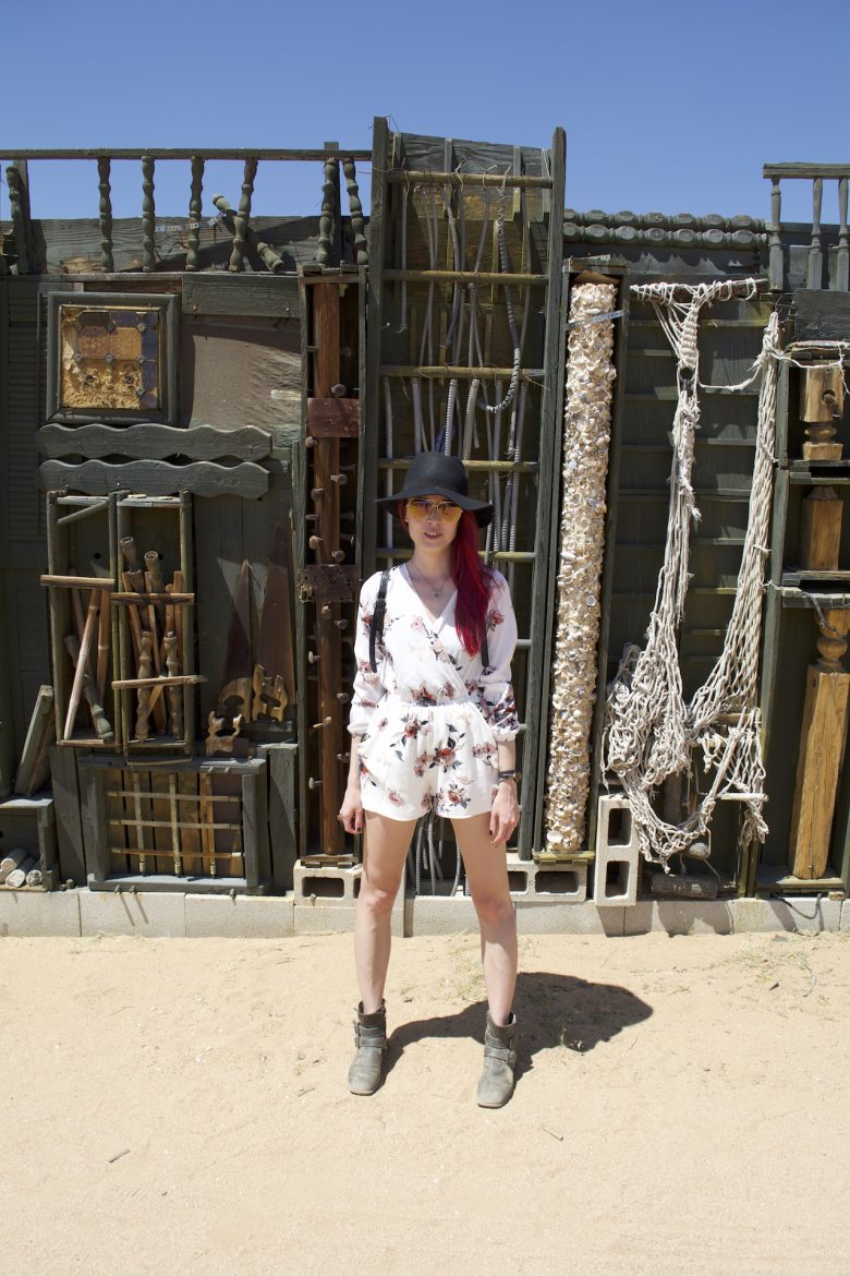 woman against antique furniture display in Joshua Tree