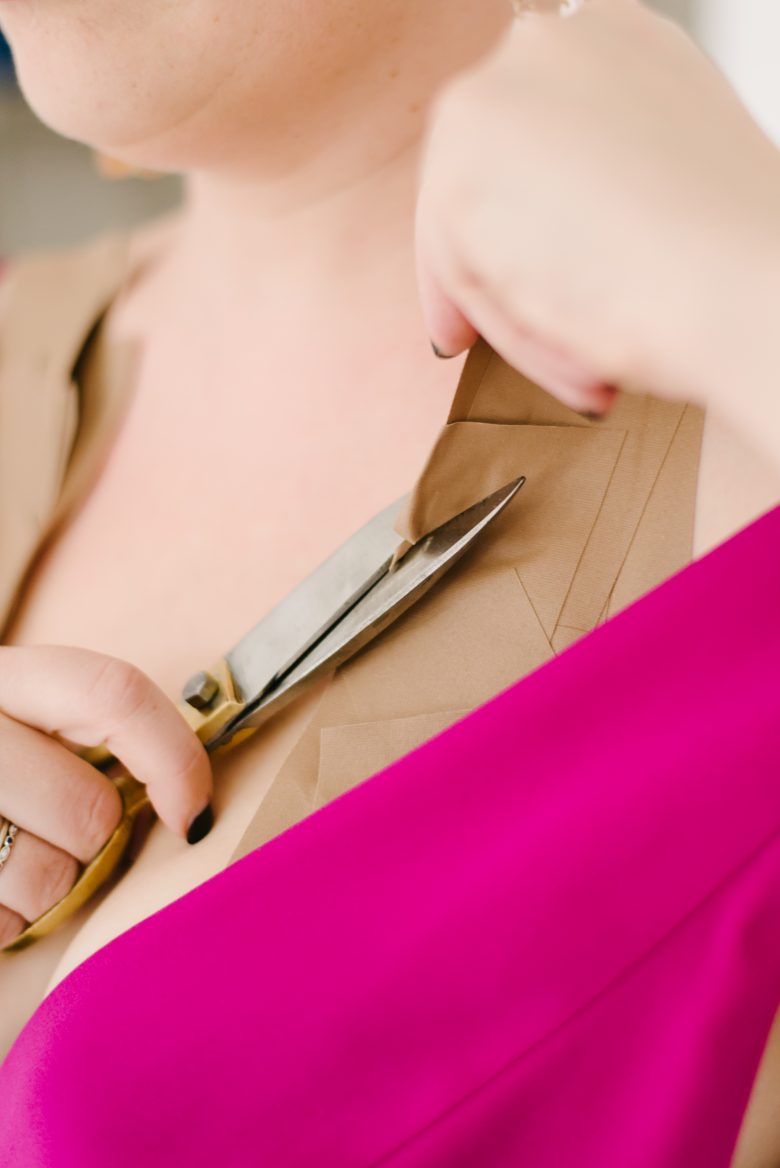 closeup of scissors cutting gaffer tape bra down to size