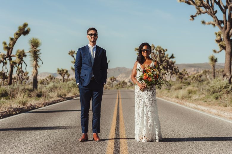 bride and groom standing on Joshua Tree highway