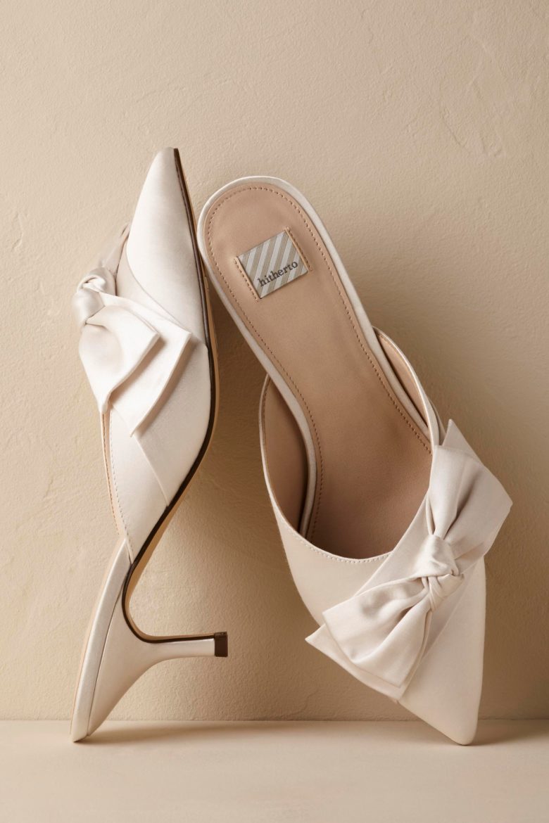 white wedding shoes with a low heel and a bow