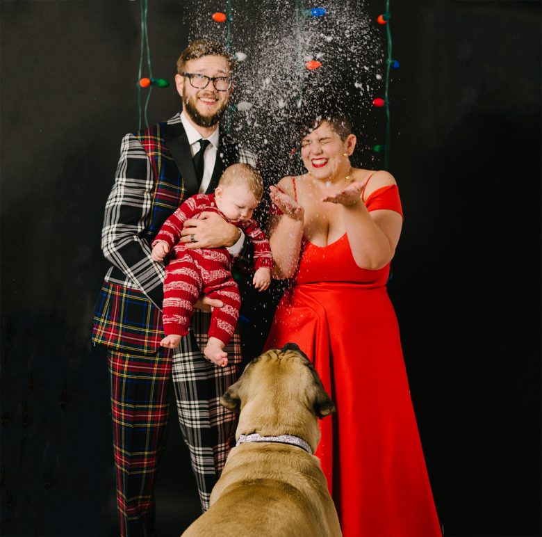 tossing snow up in the air in a family holiday card photo