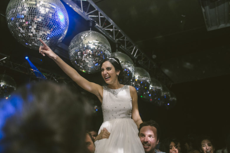 Bride being held up under disco balls