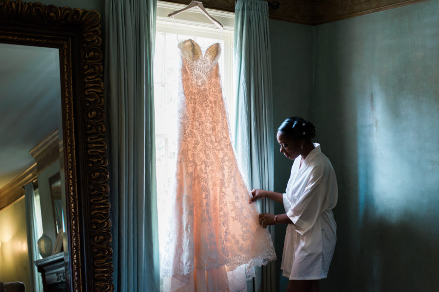 wedding vendor tips - Bride looking at her wedding dress in a window