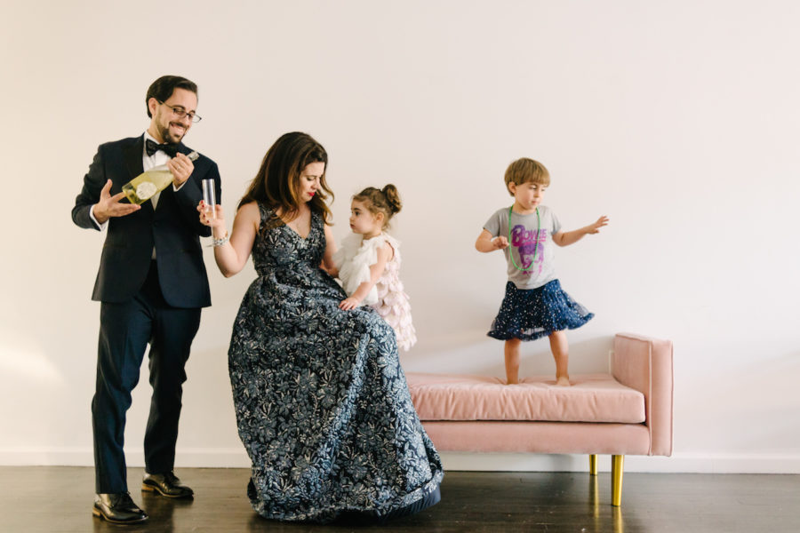 Family in black tie on a pink couch