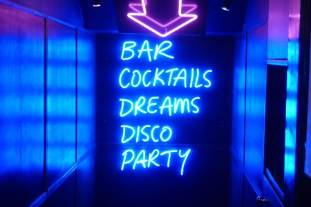neon sign saying "bar cocktails dreams disco party"