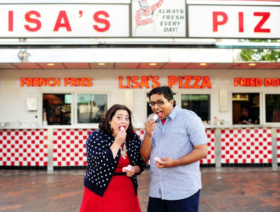 engagement session photo of a couple eating fried dough