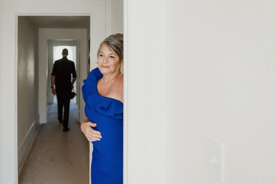 Mom in a blue dress watching the bride