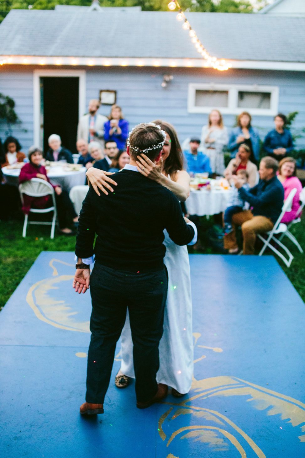 a couple dancing on their diy dance floor at their backyard wedding